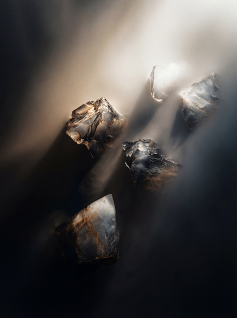 Generative art print of scattered ice fragments on dark water, aerial view, glowing backlit details, framed in matte black solid wood.