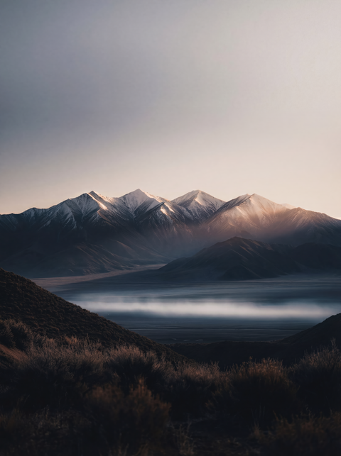 Generative art print of the Sangre de Cristo Mountains at dawn, panoramic view, valley mist, snow-capped peaks, framed in matte black solid wood.