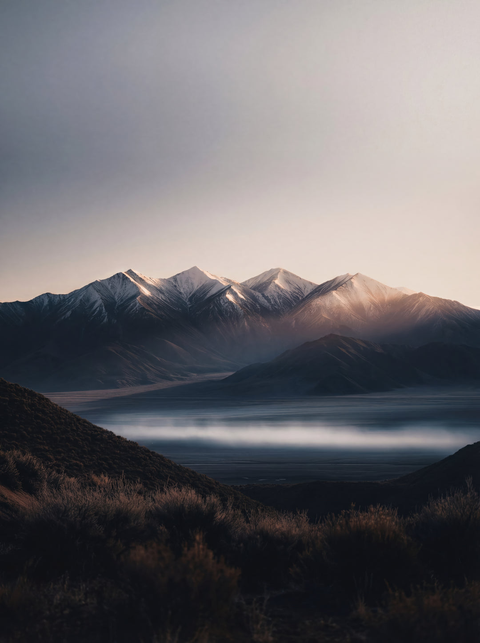 Generative art print of the Sangre de Cristo Mountains at dawn, panoramic view, valley mist, snow-capped peaks, framed in matte black solid wood.