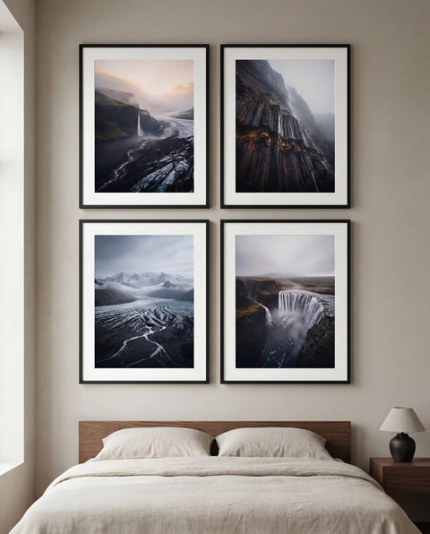 Two framed black-and-white landscape prints, a glacier and a waterfall, on a gallery wall