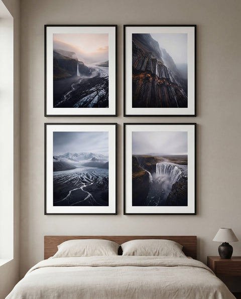 Quiet 2x2 grid gallery wall with framed fine art prints above a bed